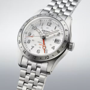 Silver Seiko watch with a white face on a light gray background
