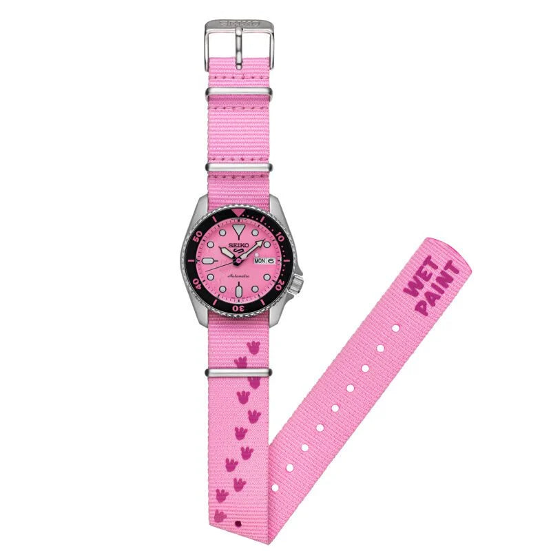 Pink watch with a heart patterned strap on a white background