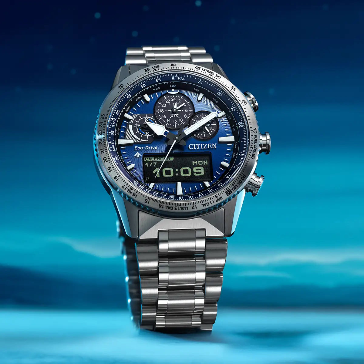 Silver Citizen watch with blue face on a blue gradient background