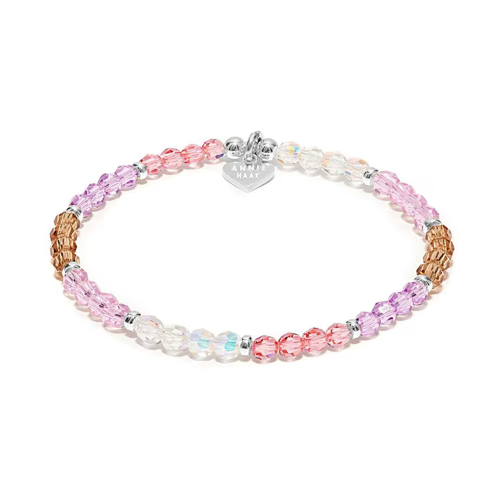 Multicolored beaded bracelet with a heart-shaped tag on a white background