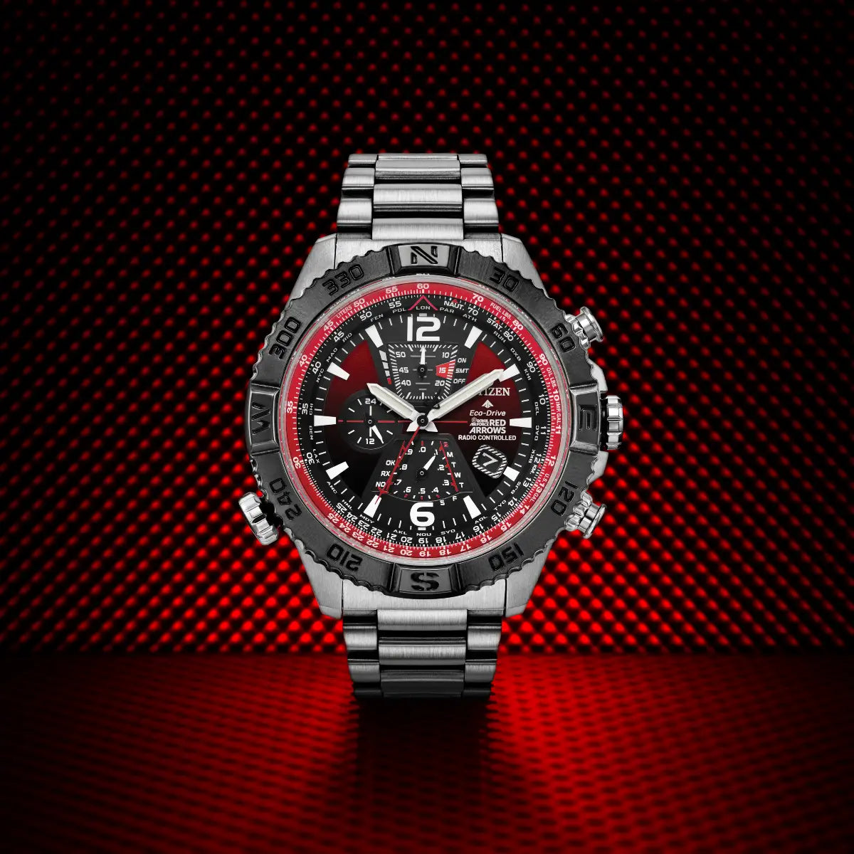 Luxury watch with red and black face on a red carbon fiber background
